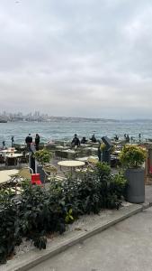 a group of people sitting at tables by the water at Lux sea view willas in Istanbul