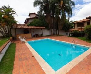 a swimming pool in the backyard of a house at Pousada Wafeh Pampulha Suítes in Belo Horizonte