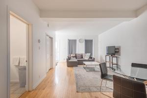 a living room with a couch and a table at AAA Location Condo & FREE Parking in Montreal