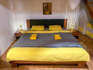 a bedroom with a bed with yellow sheets and yellow pillows at La Stella di Budapest in Budapest