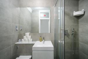kings cross St Pancras luxury apt في لندن: حمام مع دش ومغسلة ومرحاض