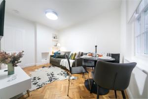 a living room with a couch and a table at kings cross St Pancras luxury apt in London