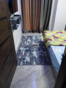 a bedroom with a bed and a rug on the floor at Hurghada City Apartment2 in Hurghada