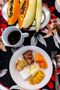 a table with two plates of food and a cup of coffee at Pisom Hotel in Santo André