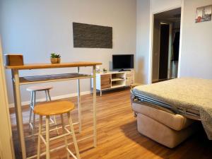 a bedroom with a bed and a table and two stools at Leo’s Home in Sesto San Giovanni