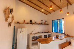 a kitchen with a sink and a refrigerator in a room at CasaPEDROCasaMarcio - Soure, Marajó PA in Soure