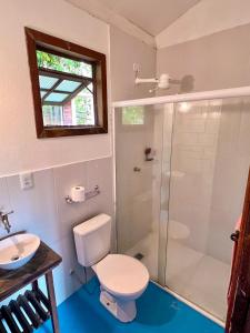 a bathroom with a shower and a toilet and a sink at Vila Flor Eco Centro in Diogo