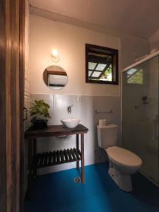 a bathroom with a toilet and a sink at Vila Flor Eco Centro in Diogo