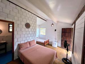 a bedroom with a bed and a room with a window at Vila Flor Eco Centro in Diogo