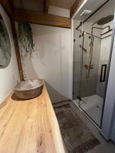 a bathroom with a stone sink and a shower at Chalet Hoge Kempen in Zutendaal