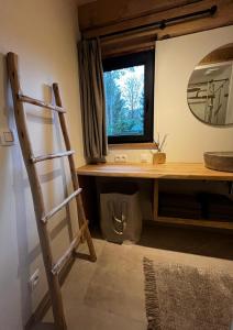 a bathroom with a ladder next to a window at Chalet Hoge Kempen in Zutendaal