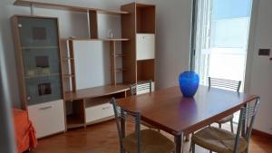 a dining room table with a blue vase on it at OASI CL in Bari