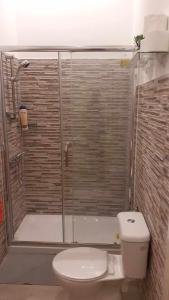 een badkamer met een toilet en een glazen douche bij VICTORIA HOSTEL 