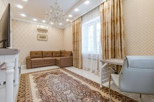 a living room with a couch and a window at Венский Квартал-29 Apartments- Expo, Mega Silky Way in Prigorodnyy