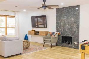 a living room with a couch and a fireplace at Home Away from Home in Spring in Spring