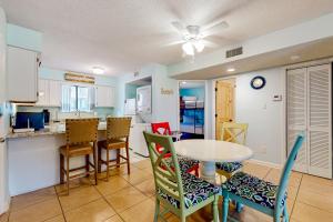 a kitchen and dining room with a table and chairs at Wolf Bay Villas 106 in Orange Beach
