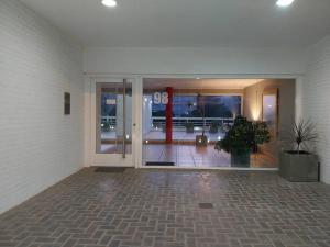 an empty lobby with a large glass door in a building at Apartamento frente al Mar para 7 in Pinamar