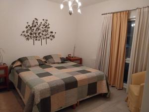 um quarto com uma cama com um cobertor xadrez em Apartamento frente al Mar para 7 em Pinamar