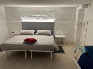 a bedroom with a bed with a red bag on it at Agriturismo Villa Dei Gelsi in Cotignola