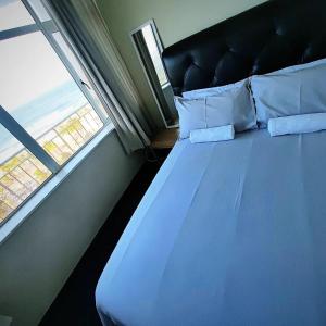 a bed in a room with a window at NO: 75 WINDEMERE HOLIDAY FLAT in Durban