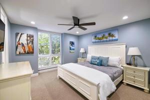 a bedroom with a bed and a ceiling fan at Brooks Beach Vacations Bungalow B116 Oceanside in Oceanside +25 photos