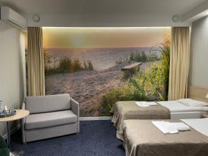 a hotel room with two beds and a view of the beach at Miejsca noclegowe w Arka Medical SPA in Kołobrzeg