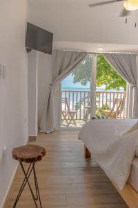 a bedroom with a bed and a view of the ocean at Aaki Hotel in Las Peñitas