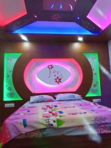 a bedroom with a bed with a pink and green ceiling at Ezhimala cruise in Nīleshwar