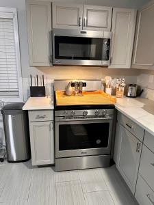 a kitchen with a stove and a microwave at New, Fun-Size Benbow House! in Garberville