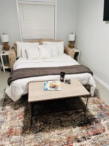 a bedroom with a bed and a coffee table with a table at New, Fun-Size Benbow House! in Garberville