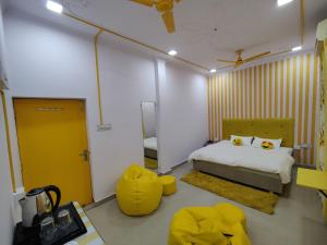 a bedroom with a bed and a yellow door at Yellow Inn Guest House in Lucknow