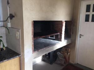 a brick oven in a room with a door at La casa de Yayo in Villa Giardino