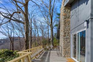 a wooden walkway leading to a building with a window at Blue View Chalet in Blowing Rock