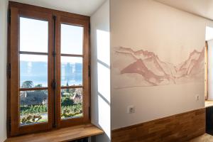 a window in a room with a mountain mural on the wall at Le DUPLEX DU LAC in Veyrier-du-Lac