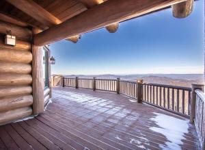 a wooden deck with a view of the mountains at Mansion In The Sky in Beech Mountain