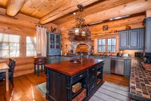 a large kitchen with wooden walls and wooden ceilings at Mansion In The Sky in Beech Mountain +35 photos
