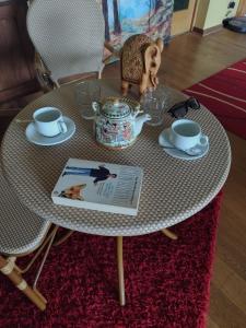 a round table with a tea set on top of it at Visok B&B in Frutillar