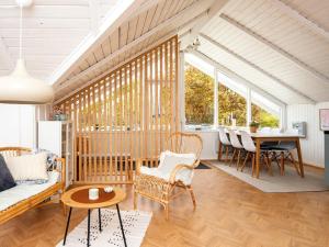 a living room with a couch and a table at Holiday home Fårvang VII in Fårvang