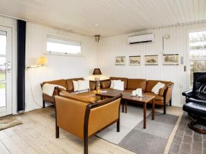 a living room with a couch and a table at 6 person holiday home in Løkken-By Traum in Løkken