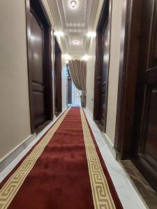 a hallway with a red carpet in a building at Luxurious vip apartment in Cairo
