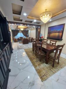 a living room with a wooden table and chairs at Luxurious vip apartment in Cairo