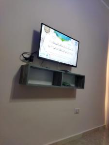 TV de pantalla plana colgada en la pared en Hurghada City Apartment2 en Hurghada