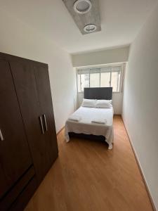 a bedroom with a bed and a large window at Apartamento en Pocitos in Montevideo