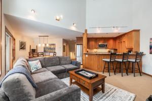 a living room with a couch and a table at Blackcomb Greens by Outpost Whistler in Whistler