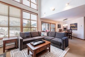 a living room with a couch and a table at Blackcomb Greens by Outpost Whistler in Whistler