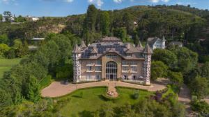 an aerial view of a large house on a hill at Carballo Hotel & Spa in Campos do Jordão