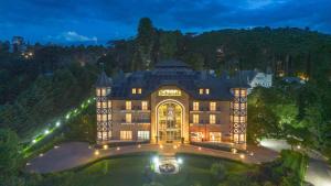 an aerial view of a mansion at night at Carballo Hotel & Spa in Campos do Jordão