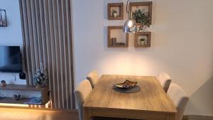 a dining room with a wooden table and chairs at Apartman K&N - Jahorinska Vila in Jahorina