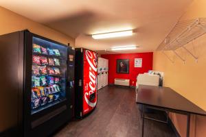 a room with a soda vending machine and a table at Rosewood Hotel- Portland East in Portland