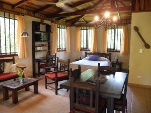 a bedroom with a bed and a table and chairs at Casas Pelicano in Playa Junquillal